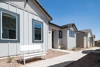 A bench in front of a row of houses